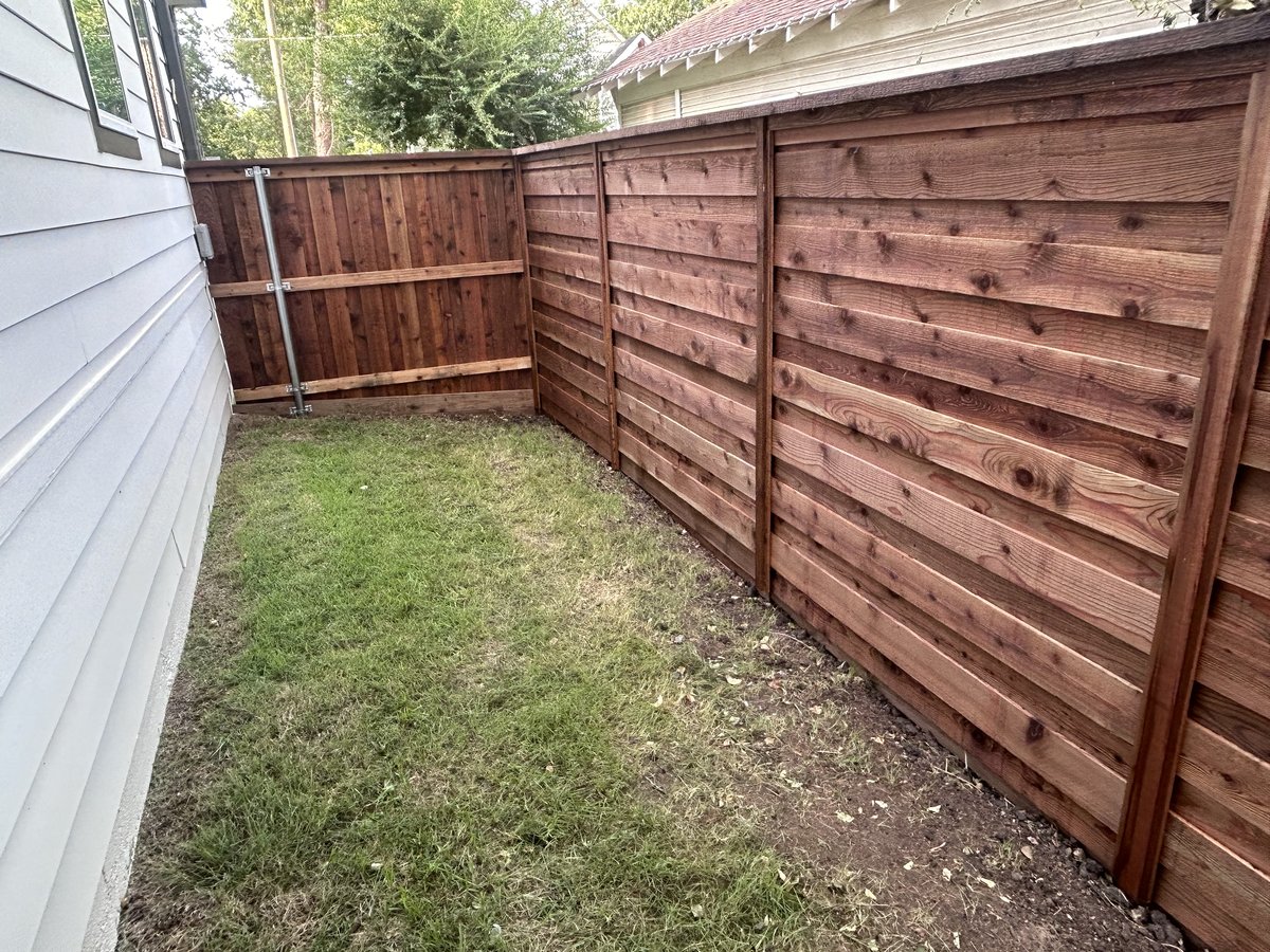 Horizontal slat wood fence in backyard