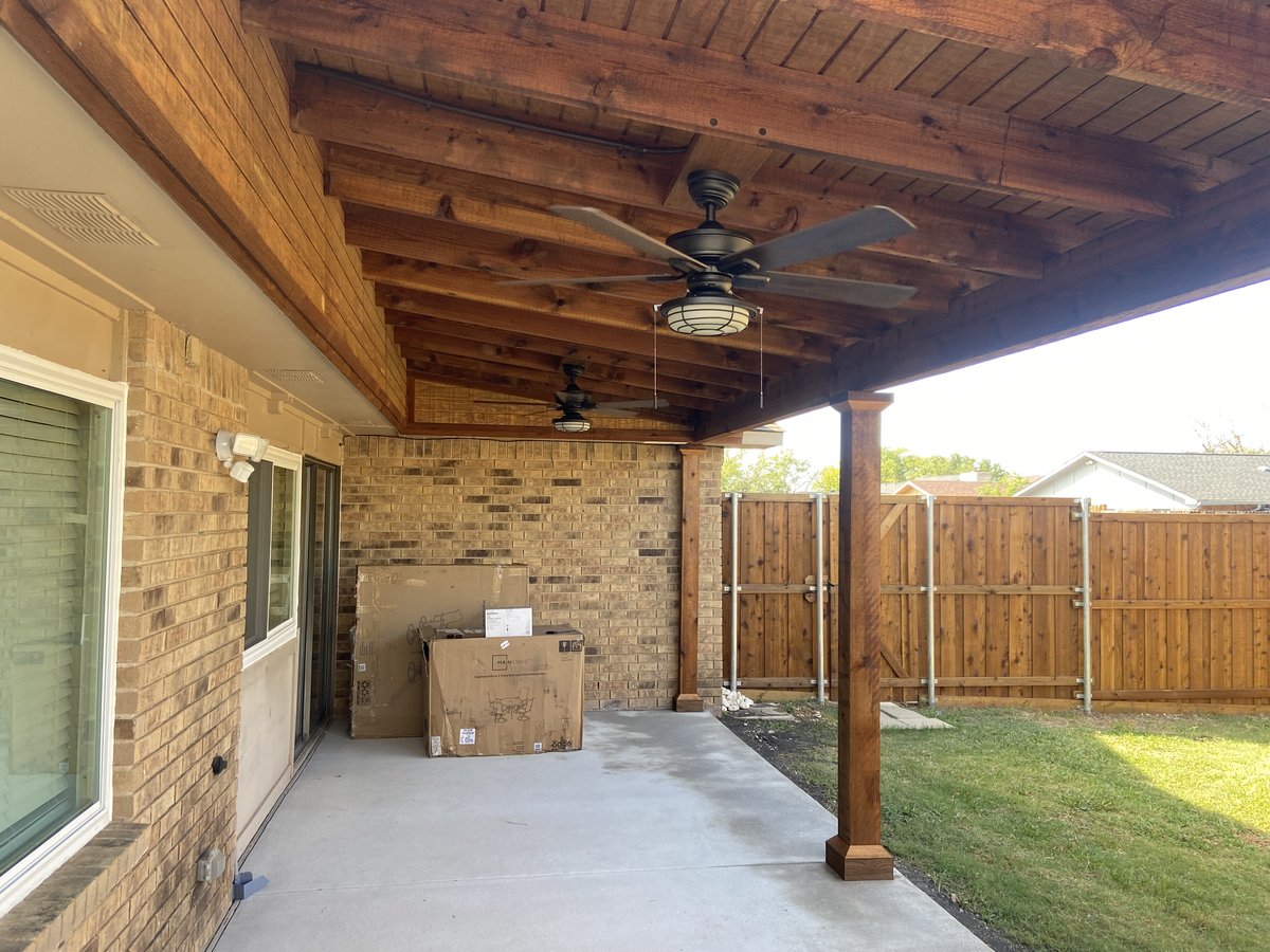 Stained patio cover interior with ceiling fans