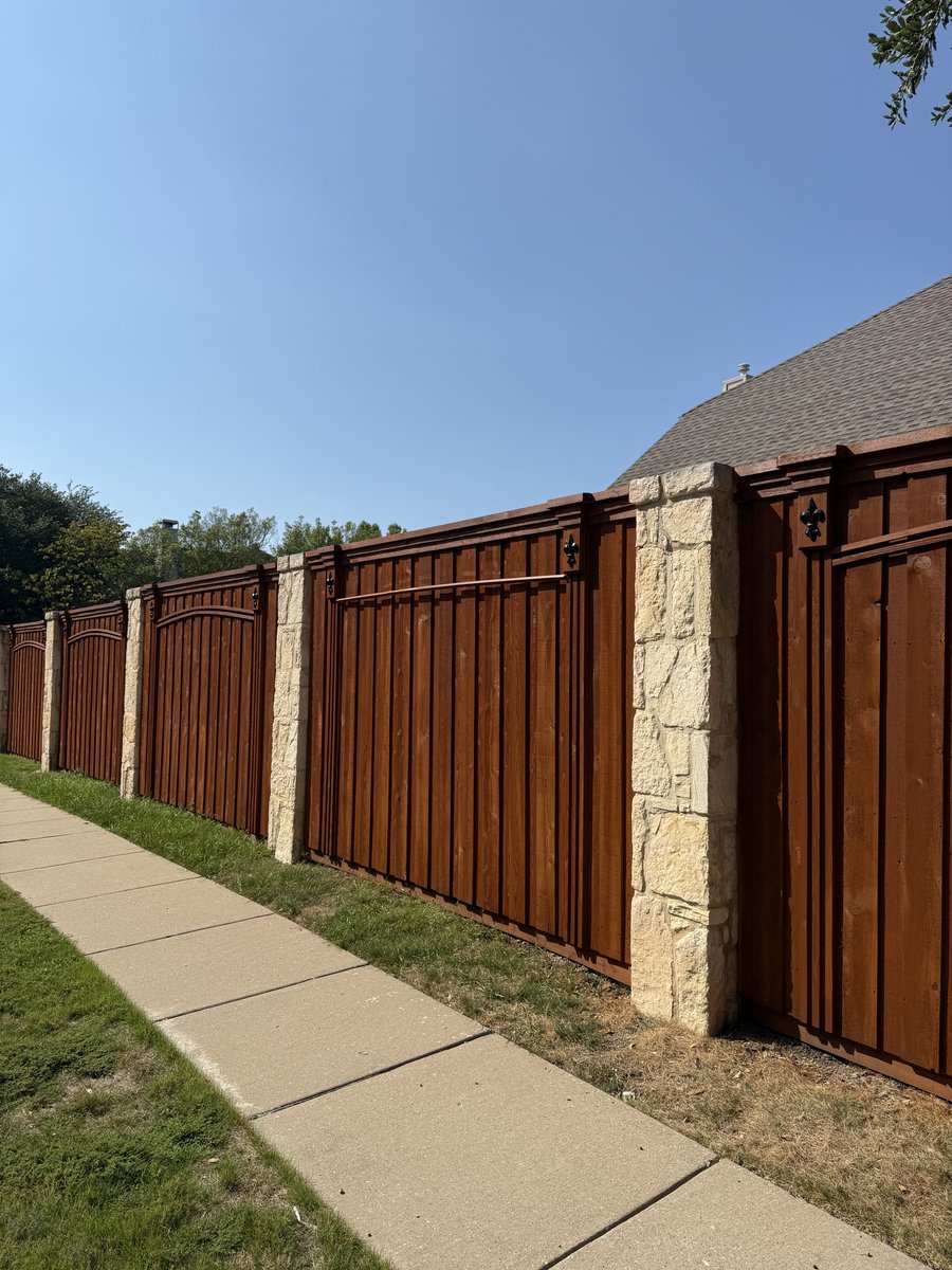 Stained wood fence with stone column accents