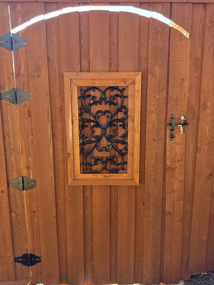 Decorative gate close-up with iron scroll insert