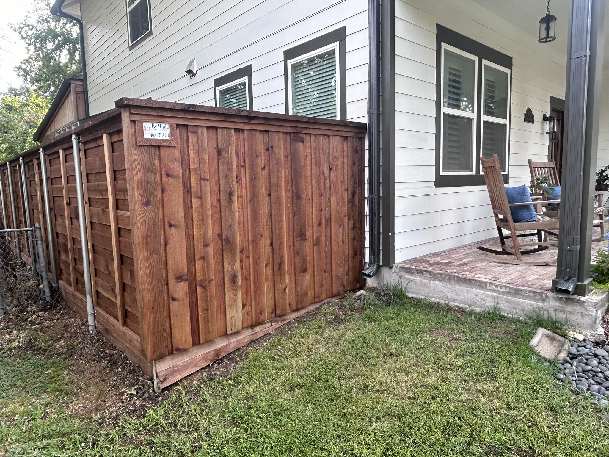 Stained cedar privacy fence with board-on-board and horizontal transition