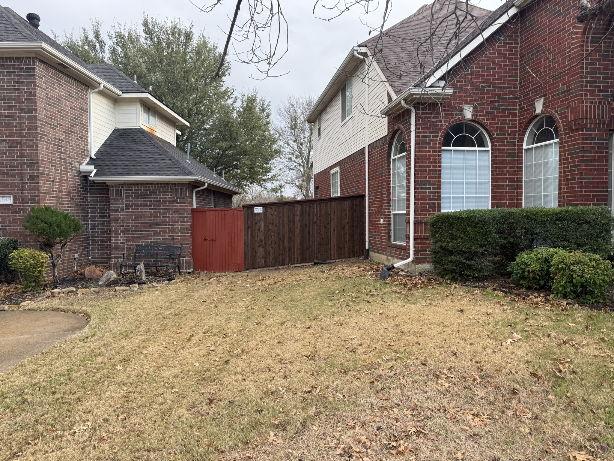 New cedar privacy fence and gate with z-bracing in landscaped side yard