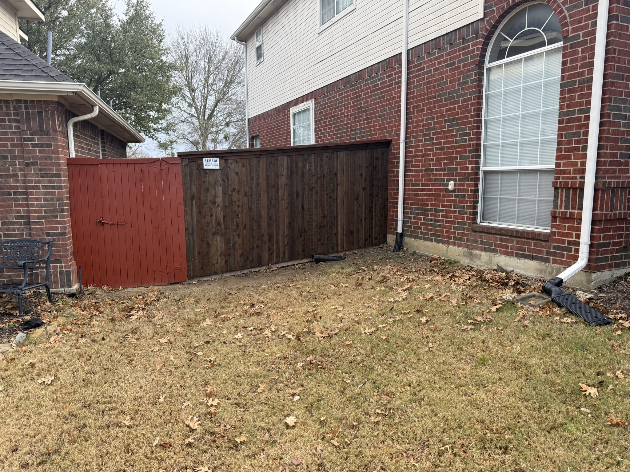 New cedar fence with privacy and open-picket sections in landscaped garden